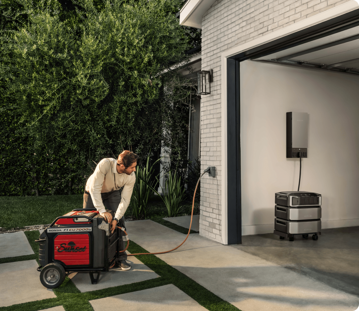 A man plugs a gas standby generator into his home's inlet box. An EcoFlow DELTA Pro Ultra is plugged into a wall-mounted Smart Home Panel 2.