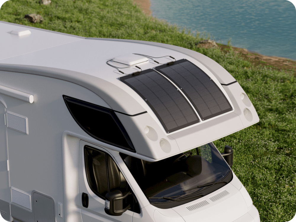 Two EcoFlow 100W Flexible Solar Panels are mounted on the curved surface of an RV.