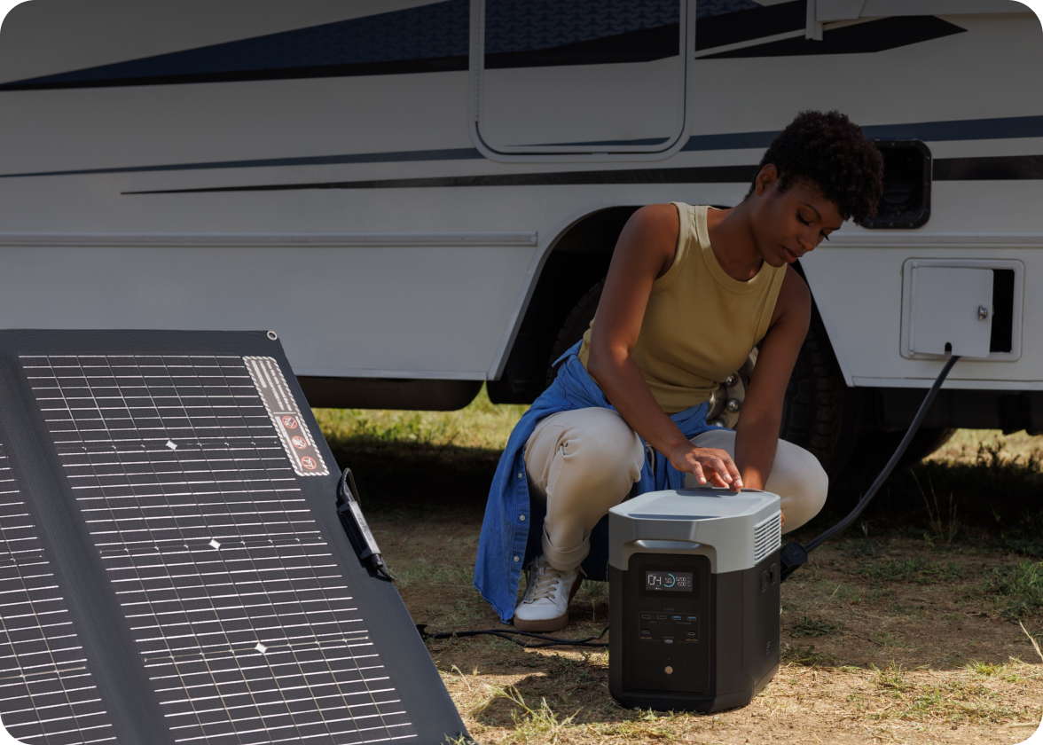 A woman connects a DELTA Pro to an EcoFlow solar panel and to her RV.