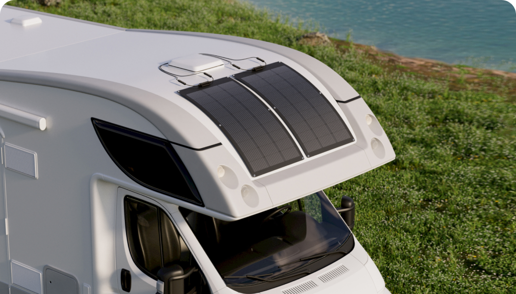 Two EcoFlow 100W Flexible Solar Panels are mounted on the curved surface of an RV.