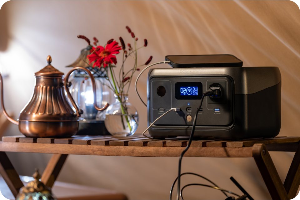 EcoFlow RIVER 2 charges a cell phone and runs appliances in a tent.
