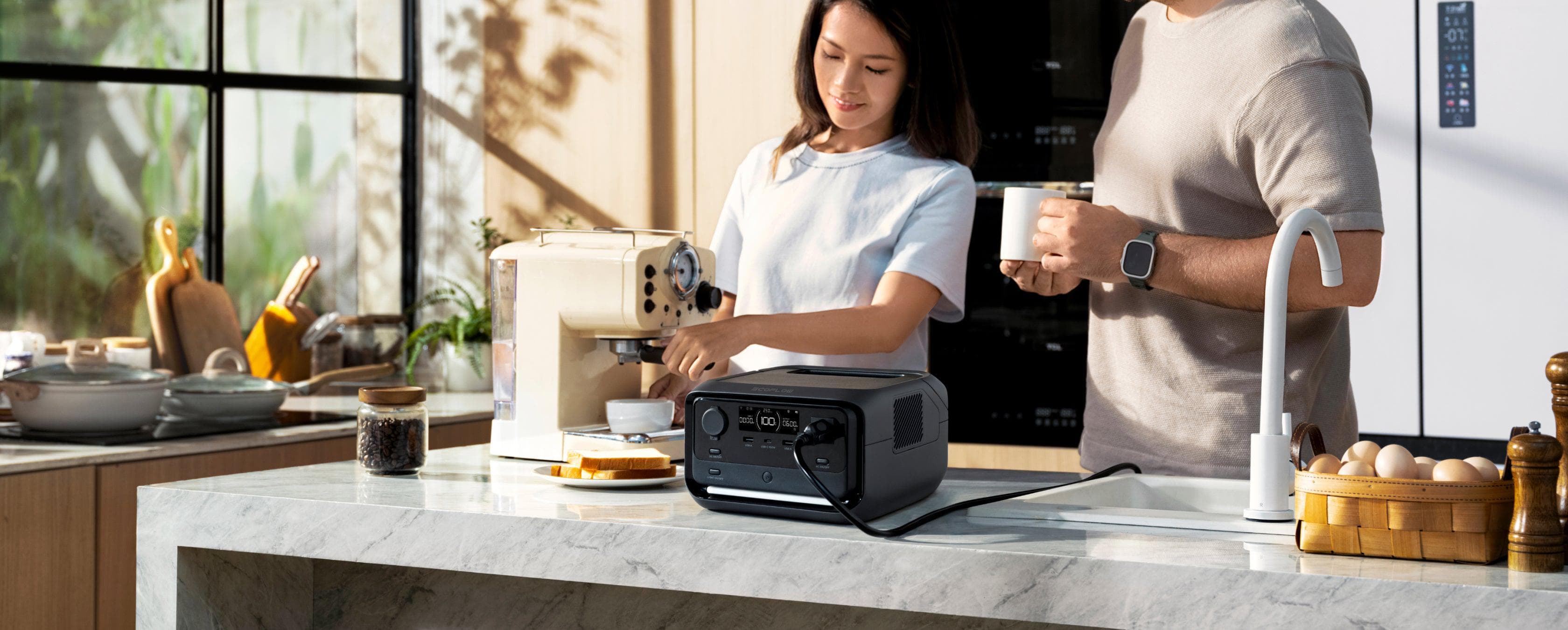 People preparing coffee with a compact EcoFlow power station on a kitchen worktop
